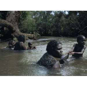  Aborigine Mothers and Children Cool off During a Swim in a 