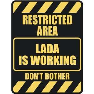   RESTRICTED AREA LADA IS WORKING  PARKING SIGN