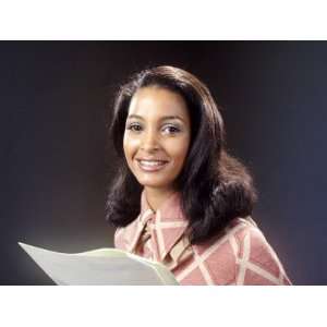  Smiling African American Woman Reading From Papers 