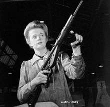 Worker posing with a Sten Mk II in the factory on May 26, 1942.