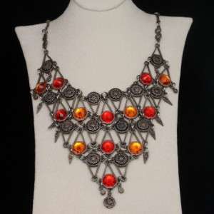 Silvertone necklace with red and orange faceted glass stones. Textured 